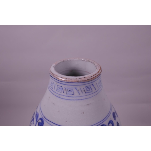 125 - A Chinese Ming style blue and white pottery double gourd vase with lotus flower decoration, 13½