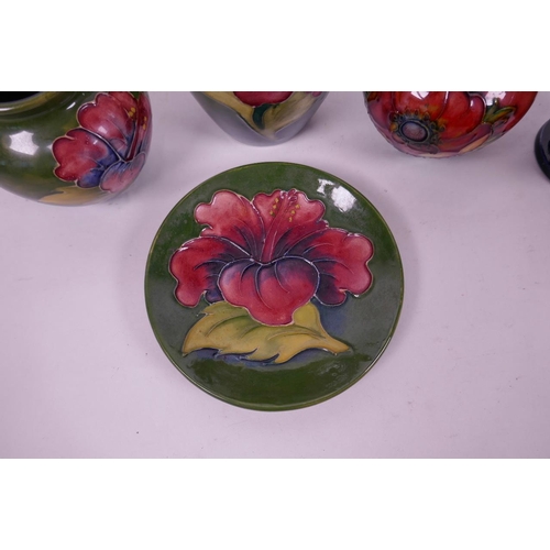 127 - Four small Moorcroft pottery vases and a matching saucer with floral decoration, largest 5