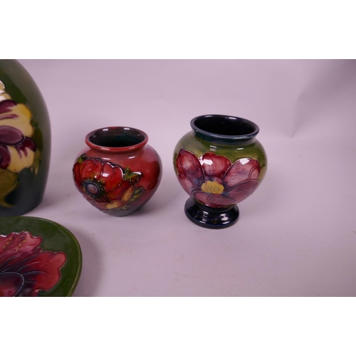 127 - Four small Moorcroft pottery vases and a matching saucer with floral decoration, largest 5