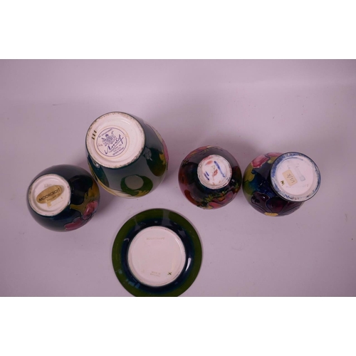 127 - Four small Moorcroft pottery vases and a matching saucer with floral decoration, largest 5