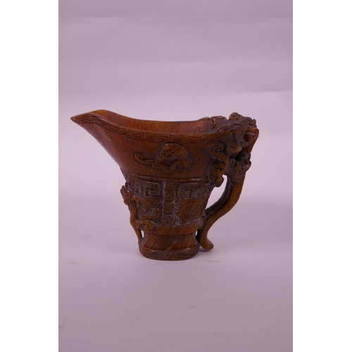 130 - A Chinese faux horn libation cup with carved kylin decoration, seal mark to base, 4½