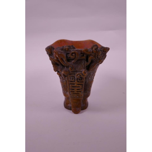 130 - A Chinese faux horn libation cup with carved kylin decoration, seal mark to base, 4½