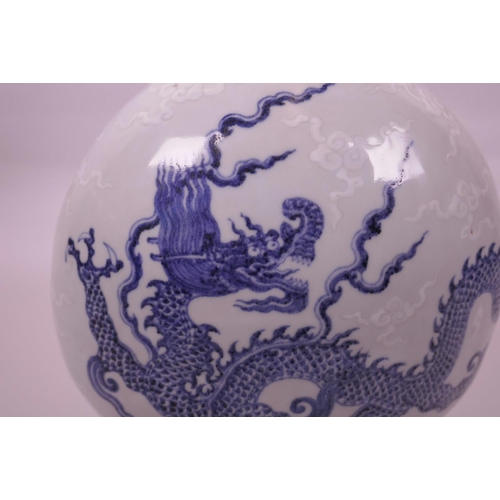 133 - A Chinese blue and white porcelain moon flask with dragon decoration, 6 character mark to base, 12½