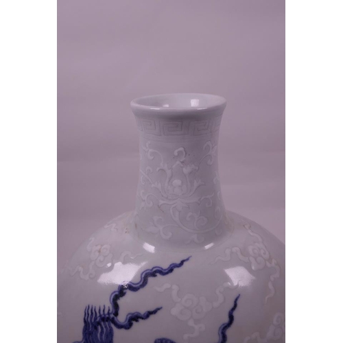 133 - A Chinese blue and white porcelain moon flask with dragon decoration, 6 character mark to base, 12½