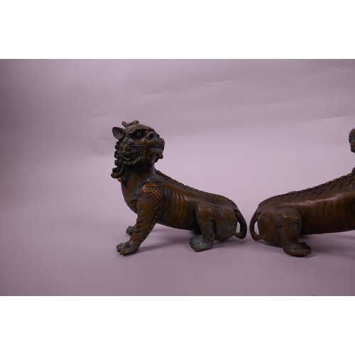 135 - A pair of Chinese bronze kylin scroll weights, 5½