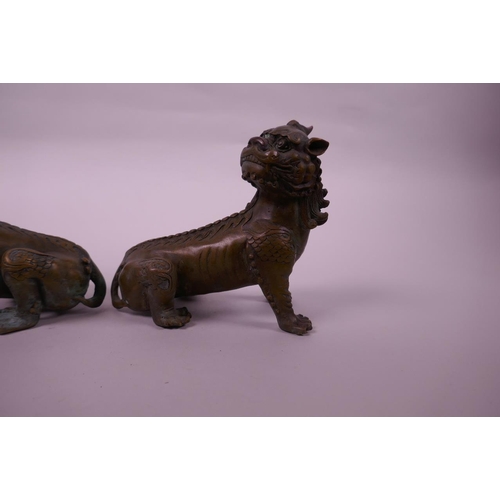 135 - A pair of Chinese bronze kylin scroll weights, 5½