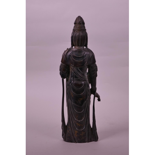 23 - A Chinese filled bronze figure of Quan Yin, 11