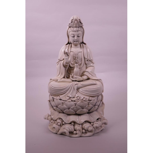 30 - A large Chinese blanc de chine Quan Yin, seated on a lotus flower, impressed seal marks verso, 16