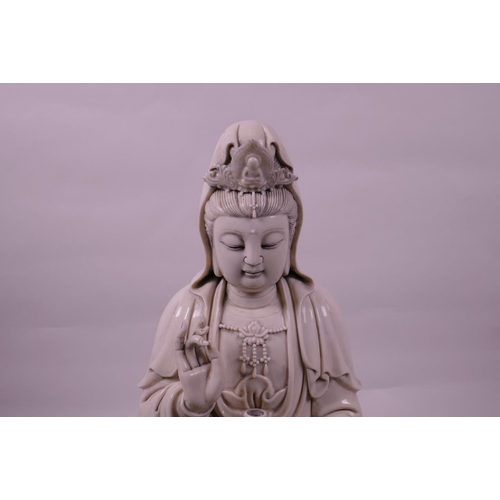 30 - A large Chinese blanc de chine Quan Yin, seated on a lotus flower, impressed seal marks verso, 16