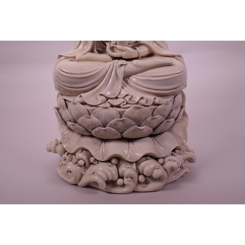 30 - A large Chinese blanc de chine Quan Yin, seated on a lotus flower, impressed seal marks verso, 16