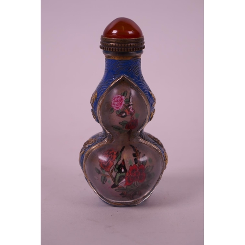 32 - A Chinese reverse painted glass snuff bottle in the form of a double gourd decorated with birds amon... 