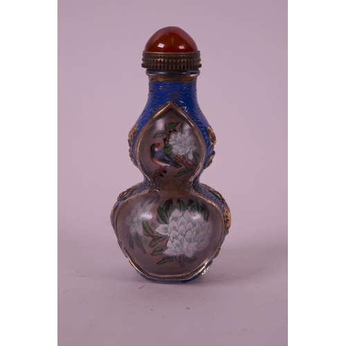 32 - A Chinese reverse painted glass snuff bottle in the form of a double gourd decorated with birds amon... 