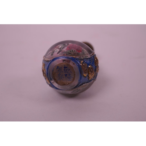 32 - A Chinese reverse painted glass snuff bottle in the form of a double gourd decorated with birds amon... 