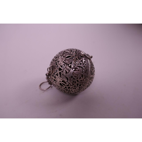 35 - A Chinese white metal incense ball decorated with birds and fruiting vines, 2