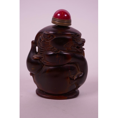 41 - A Chinese horn snuff bottle carved in the form of a dragon, 3½