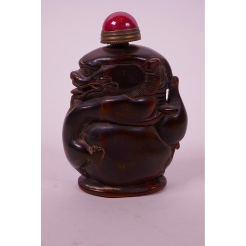 41 - A Chinese horn snuff bottle carved in the form of a dragon, 3½