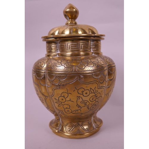 44 - An Oriental polished bronze storage jar and cover of flattened petal form having engraved bird and f... 