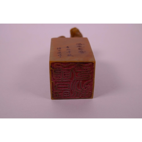 50 - A Chinese soapstone seal with a carved kylin knop and character inscription to side