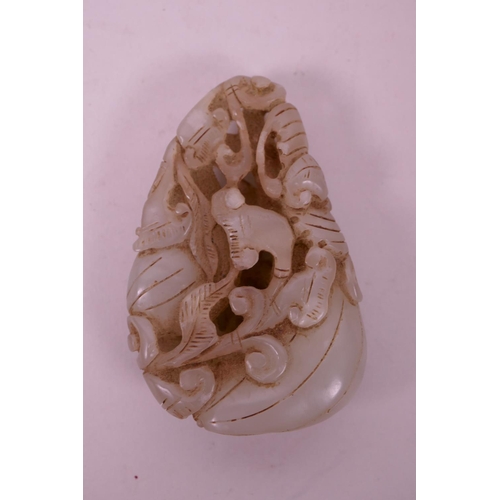 51 - A Chinese celadon jade pendant carved in the form of gourds, 2½