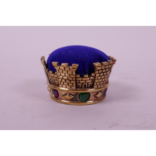 52 - A novelty gilt metal pin cushion in the form of a crown set with semi precious stones, 1½