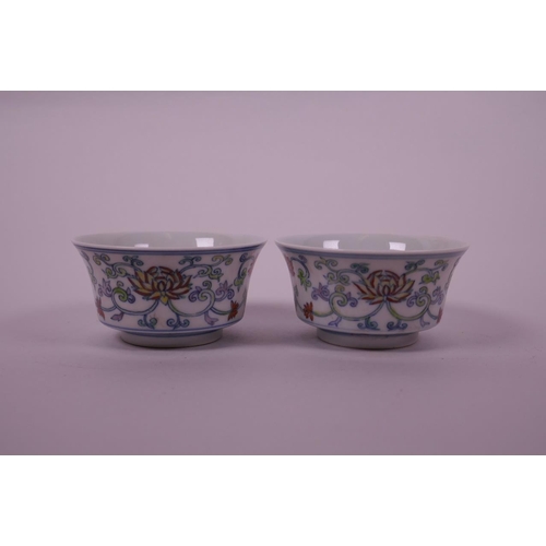 58 - A pair of Chinese doucai porcelain tea bowls decorated with a lotus flower pattern, 6 character mark... 