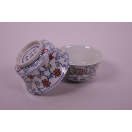 58 - A pair of Chinese doucai porcelain tea bowls decorated with a lotus flower pattern, 6 character mark... 