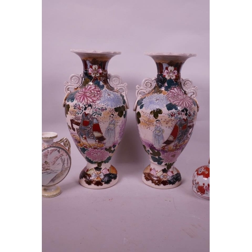 59 - A pair of Japanese Satsuma pottery two handled baluster vases decorated with figures in a garden, 12... 