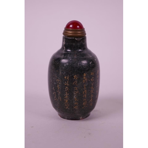 60 - A Chinese green hardstone snuff bottle with engraved and gilt character inscription, carved mark to ... 