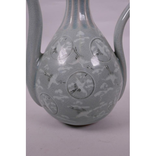 67 - A Korean celadon glazed pottery ewer, decorated with storks in flight, signed to base, 12½