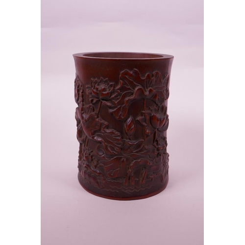 68 - A Chinese bamboo brush pot with carved lotus pond decoration, character inscription verso, 6½