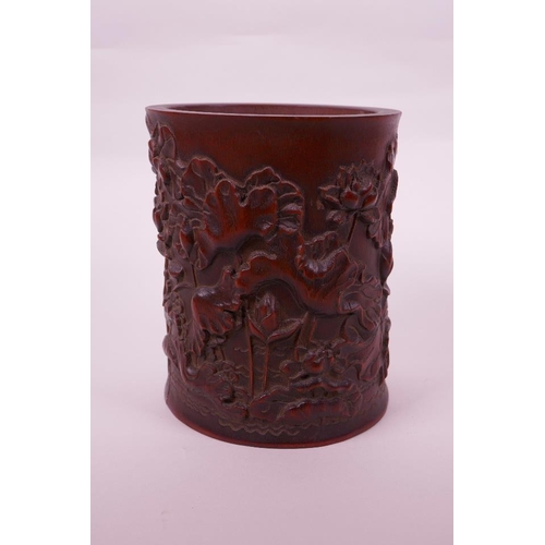 68 - A Chinese bamboo brush pot with carved lotus pond decoration, character inscription verso, 6½