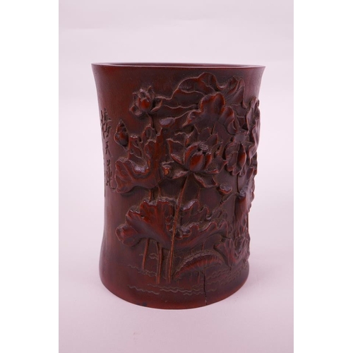 68 - A Chinese bamboo brush pot with carved lotus pond decoration, character inscription verso, 6½