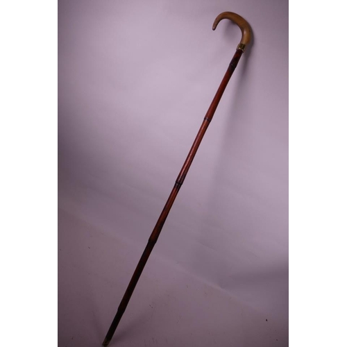 69 - A horn handled bamboo walking stick with a brass cuff, possibly rhino, 35½