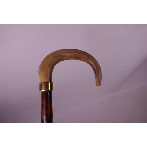 69 - A horn handled bamboo walking stick with a brass cuff, possibly rhino, 35½