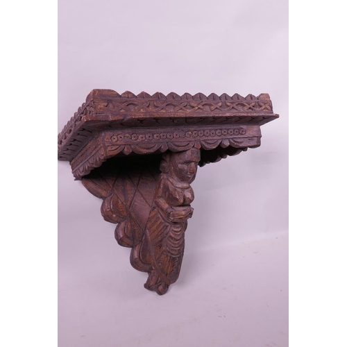 7 - An Asian carved wood wall bracket supported by a female figure, 13