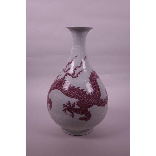 95 - A large Chinese red and white pottery pear shaped vase decorated with a dragon chasing the flaming p... 