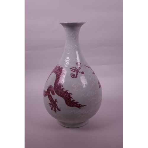 95 - A large Chinese red and white pottery pear shaped vase decorated with a dragon chasing the flaming p... 