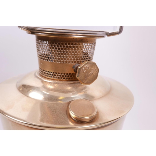 20 - An Aladdin 23 oil lamp with a brass base and reservoir, complete, 23½