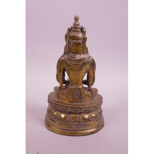 39 - A Sino-Tibetan gilt mixed metal figure of Buddha seated on a lotus throne, impressed character marks... 