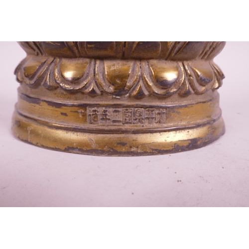 39 - A Sino-Tibetan gilt mixed metal figure of Buddha seated on a lotus throne, impressed character marks... 