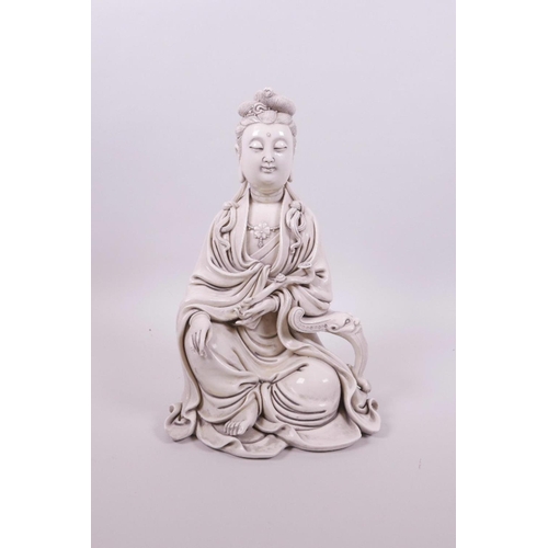 61 - A Chinese blanc de chine Quan Yin seated holding a ruyi, impressed marks verso, 10½