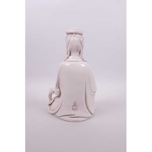 61 - A Chinese blanc de chine Quan Yin seated holding a ruyi, impressed marks verso, 10½