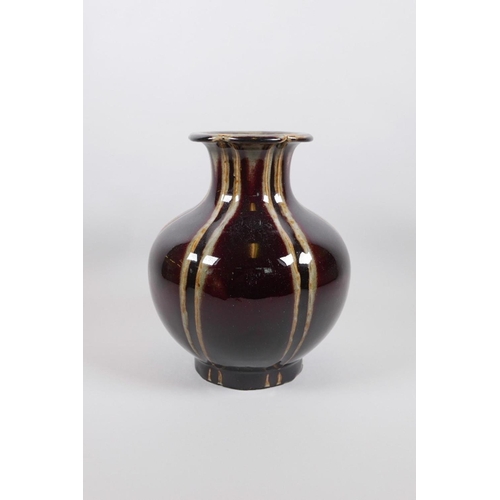 63 - A Chinese globular pottery vase with a lobed rim and burgundy flambé glaze, seal mark to base, 9