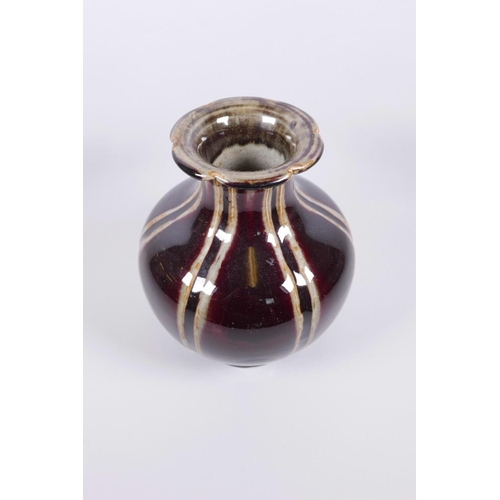 63 - A Chinese globular pottery vase with a lobed rim and burgundy flambé glaze, seal mark to base, 9