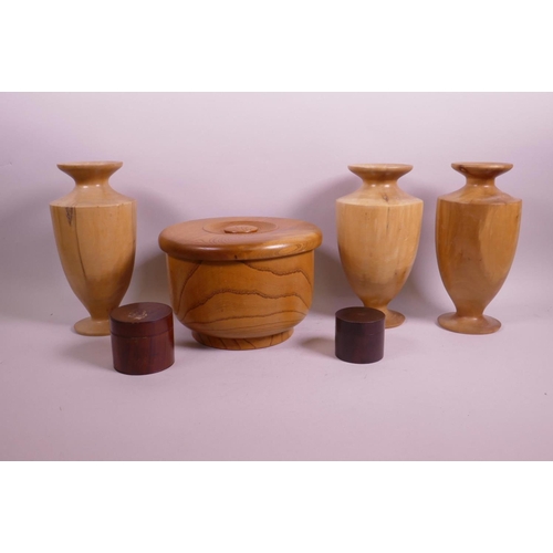 72 - A quantity of treen to include three turned vases, two small pots and covers and a Japanese rice bow... 