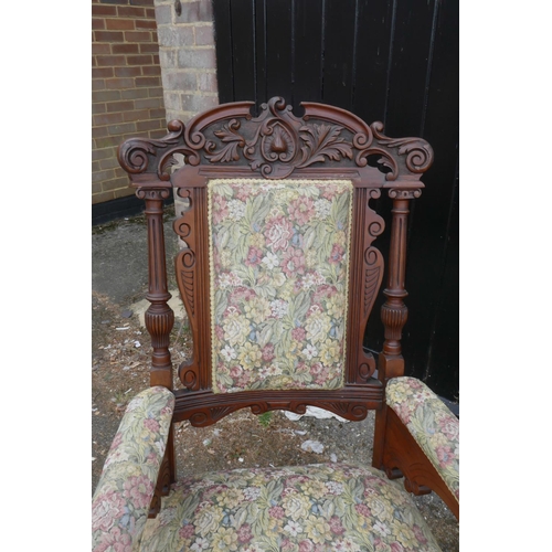 1207 - A pair of C19th walnut open armchairs with carved scroll and palm classical decoration, 44½