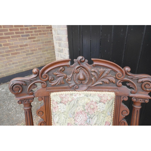 1207 - A pair of C19th walnut open armchairs with carved scroll and palm classical decoration, 44½