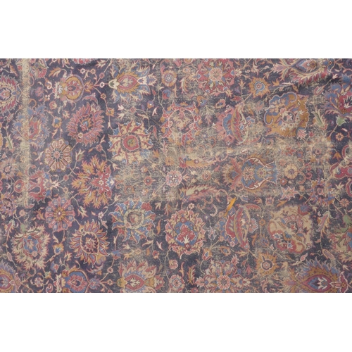 1206 - A large blue ground Persian wool rug with stylised floral decoration, and a red border (worn), 108