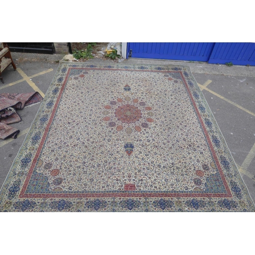 1205 - A large Persian pattern cream ground wool carpet, 143