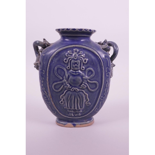 10 - A Chinese blue glazed pottery flask with two dragon shaped handles and raised decoration of an immor... 